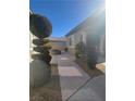 An inviting backyard area with decorative shrubs and a cozy fire pit for outdoor enjoyment at 10548 Ettenmoor Ave, Las Vegas, NV 89135