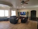 Spacious living room with tile flooring, recessed lighting, and comfortable seating arrangement at 10548 Ettenmoor Ave, Las Vegas, NV 89135