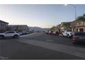 Street view showing multiple parked cars and mountain view at 1145 Belton Lake Ave, North Las Vegas, NV 89086
