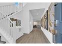 Inviting home entryway with bright white accents, wood floors and modern decor at 1297 Ventura Cliffs Ave, Henderson, NV 89012