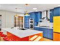 Modern kitchen features blue cabinets, white countertops, stainless steel appliances and colorful design elements at 1679 Raindance Way, Las Vegas, NV 89169