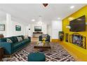 Staged living room with bright accents and patterned rug, perfect for relaxing and entertaining at 1679 Raindance Way, Las Vegas, NV 89169