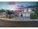 Two story home at dusk with front yard landscaping and a two car garage at 1808 Piccolo Way, Las Vegas, NV 89146