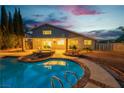 A luxurious pool and patio area that features a built in seating area with an overhang at 1808 Piccolo Way, Las Vegas, NV 89146