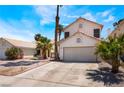 Charming two-story home featuring a two-car garage, desert landscaping, and inviting curb appeal at 1922 Falcon Ridge St, Las Vegas, NV 89142