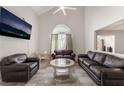 Inviting living room featuring a vaulted ceiling, modern tile floors, and comfortable seating at 1922 Falcon Ridge St, Las Vegas, NV 89142