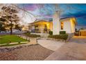 Inviting exterior with a covered porch, manicured landscaping, and a walkway that lead to the front door at 200 E Desert Rose Dr, Henderson, NV 89015