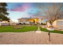 Lovely front yard with green grass, a cute mailbox, desert landscaping, and inviting entrance at 200 E Desert Rose Dr, Henderson, NV 89015