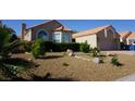 Lovely single-story home boasts a well-kept gravel yard and attached two-car garage at 2874 Tori Way, Henderson, NV 89074