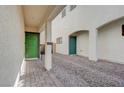 Cozy courtyard with stone pavers and a green entry door at 387 Larksong Ave, Henderson, NV 89011