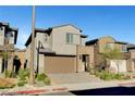 Two-story home boasts a two-car garage and modern architectural design, complemented by desert landscaping at 40 Strada Moscato, Henderson, NV 89011