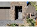 Inviting front entryway with stone columns and pavers, providing a welcoming approach to the home at 40 Strada Moscato, Henderson, NV 89011
