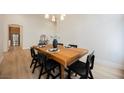 Formal dining room featuring wood table, seating for six, and modern decor at 4065 Genoa Dr, Las Vegas, NV 89141