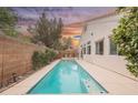 Private backyard featuring a long swimming pool and lush landscaping at 4065 Genoa Dr, Las Vegas, NV 89141