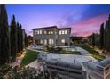 Expansive backyard featuring a pool, patio area with seating, and lush landscaping, perfect for outdoor living at 4220 San Alivia Ct, Las Vegas, NV 89141