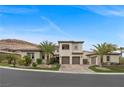 Stunning two-story home boasts a three-car garage, desert landscaping, and elegant curb appeal at 4220 San Alivia Ct, Las Vegas, NV 89141