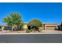 Beautiful single-story home featuring desert landscaping, a two car garage, and a mature shade tree at 4260 Helena Cove Ct, Las Vegas, NV 89129
