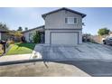 Two-story home featuring a two-car garage, desert landscaping, and a long driveway at 4474 Dawley Ct, Las Vegas, NV 89104