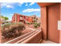 Balcony view showcasing the condo complex with desert landscaping and clear blue skies at 4730 E Craig Rd # 1115, Las Vegas, NV 89115