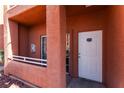Exterior view of a condo entrance with white door, unit number, and a small balcony at 4730 E Craig Rd # 1115, Las Vegas, NV 89115