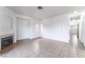 Spacious living room featuring neutral tile flooring, a fireplace, and white walls at 4730 E Craig Rd # 1115, Las Vegas, NV 89115