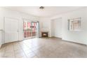 Bright living room with fireplace, sliding glass doors to the balcony, and tile flooring at 4730 E Craig Rd # 1115, Las Vegas, NV 89115