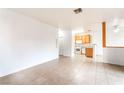 Open-concept living area featuring tile flooring, bright walls, and a view into the kitchen at 4730 E Craig Rd # 1115, Las Vegas, NV 89115