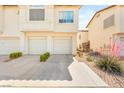Charming townhome featuring a private attached garage and convenient driveway at 4830 Grey Wolf Ln # 104, Las Vegas, NV 89149