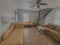Open living room with staircase, tile flooring, and comfortable seating arrangement at 4910 Elizabeth St, Pahrump, NV 89048