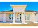 Close-up of the front entrance with a modern glass door and elegant outdoor lighting fixtures at 5400 E Grain Mill Rd, Pahrump, NV 89061