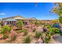 Lush backyard featuring a pergola-covered patio and meticulous landscaping with artificial turf at 5429 Blinding Lights St, North Las Vegas, NV 89081