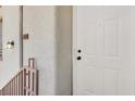 Close-up of a private condo front entrance with a white door and sleek hardware and lighting at 5655 E Sahara Ave # 2009, Las Vegas, NV 89142