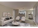 Inviting living room with neutral decor, wood floors, and an open layout that flows seamlessly to the kitchen at 5710 E Tropicana Ave # 1216, Las Vegas, NV 89122