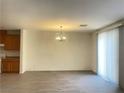 Living room featuring gray floors, a chandelier, and natural light from the window at 6255 W Arby Ave # 239, Las Vegas, NV 89118