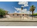 Inviting single-story home with a fenced yard, mature landscaping and an expansive front lawn at 629 N 16Th St, Las Vegas, NV 89101