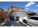 A well maintained garage and driveway provide ample parking space at this suburban home at 6812 Sheffield Dr, Las Vegas, NV 89108