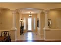 Grand foyer with columns and decorative lighting, leading to other living areas at 7325 Rustic Crest St, Las Vegas, NV 89149