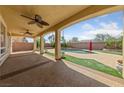 Expansive covered patio area featuring ceiling fans overlooking the backyard pool and lush landscaping at 8547 Benidorm Ave, Las Vegas, NV 89178