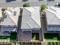 An aerial view shows the backyard of this property with desert landscaping, a covered patio, and a small putting green at 888 Cherry Glen Pl, Las Vegas, NV 89138