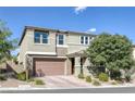 Inviting two-story home with a brick-paved driveway, complemented by desert landscaping, and a well-maintained facade at 888 Cherry Glen Pl, Las Vegas, NV 89138