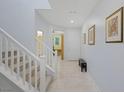 Bright foyer with staircase, neutral paint, tile floor and artwork at 888 Cherry Glen Pl, Las Vegas, NV 89138