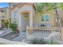 Inviting front porch area with seating, desert landscaping, and a secure front door for added privacy at 9065 Adorable Ave, Las Vegas, NV 89149