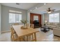 Open-concept living and dining area with tile floors and large windows at 9780 Ziegler Ave, Las Vegas, NV 89148
