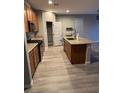 Open kitchen with stainless steel appliances, an island and gray flooring at , Las Vegas, NV 89148
