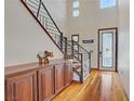 Bright foyer with hardwood floors, a staircase, and an elegant entry door at 10520 Maystar Ln, Las Vegas, NV 89135