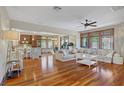 Spacious living room featuring hardwood floors and large windows for ample natural light at 10520 Maystar Ln, Las Vegas, NV 89135