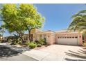 Lovely single-story home featuring a well-manicured lawn, mature trees and a spacious three car garage at 10573 Bambola Pl, Las Vegas, NV 89135
