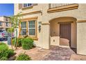 Charming townhouse entrance with brick walkway, quaint landscaping, and covered doorway at 1201 Seaboard Ct, Henderson, NV 89002