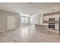 Open-concept living room featuring tile floors, abundant natural light, and access to a modern kitchen at 1201 Seaboard Ct, Henderson, NV 89002