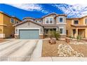 Charming two-story home with a two-car garage and desert landscaping with a beautiful, natural rock feature at 140 Rolling Cove Ave, Henderson, NV 89011